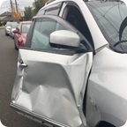 A vehicle door is damaged from an accident.